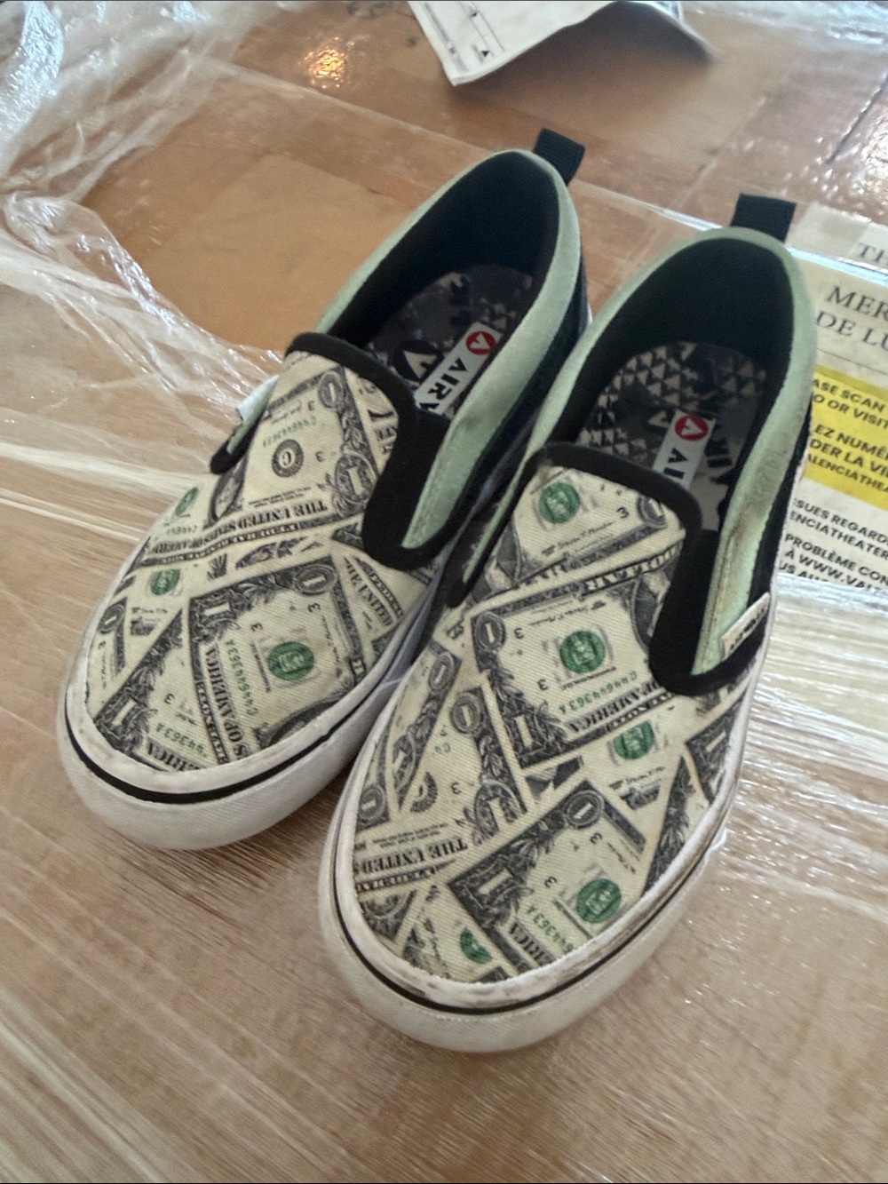 Airwalk Kids Slip-On Sneakers in White, Black & Green Dollar Print